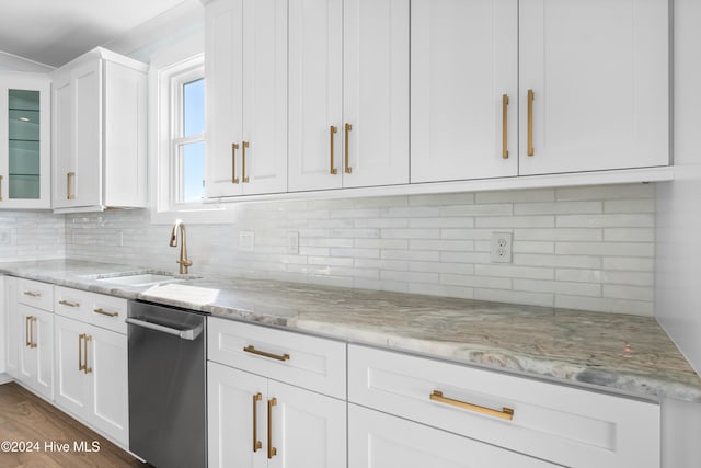 kitchen featuring white cabinets, light stone countertops, and stainless steel dishwasher