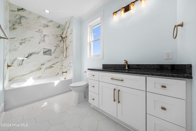 full bathroom featuring vanity, toilet, tiled shower / bath combo, and tile patterned flooring