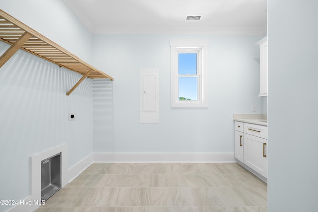 laundry area with hookup for an electric dryer, electric panel, and ornamental molding