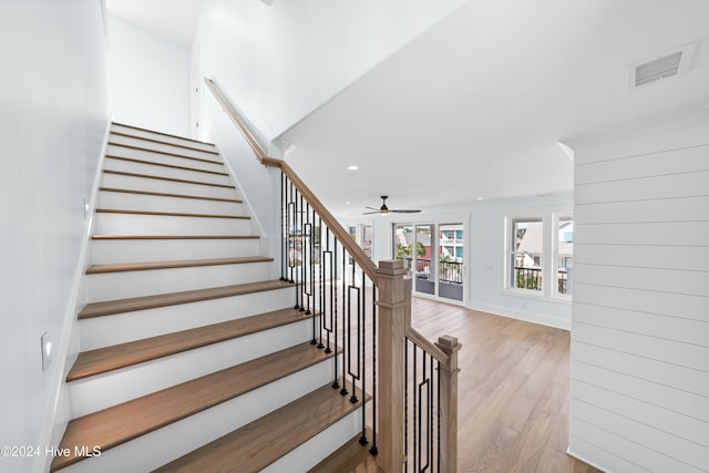 staircase with hardwood / wood-style flooring