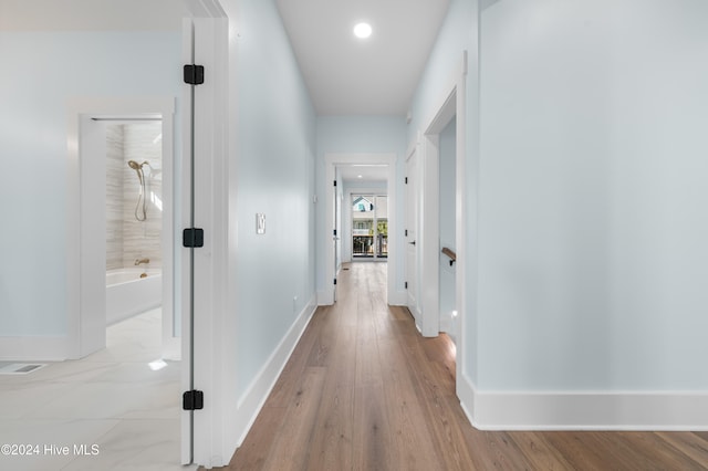 hallway with light wood-type flooring