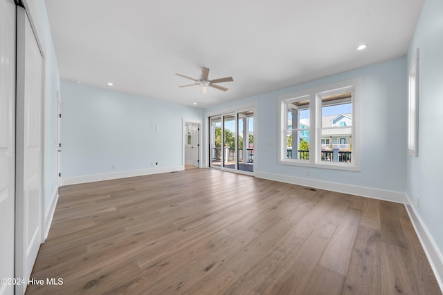 interior space with wood-type flooring and ceiling fan