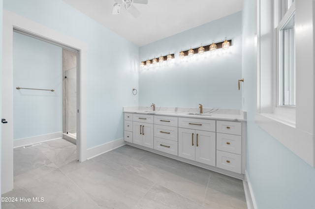 bathroom with vanity, plenty of natural light, ceiling fan, and walk in shower