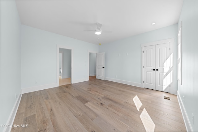 spare room featuring light wood-type flooring and ceiling fan