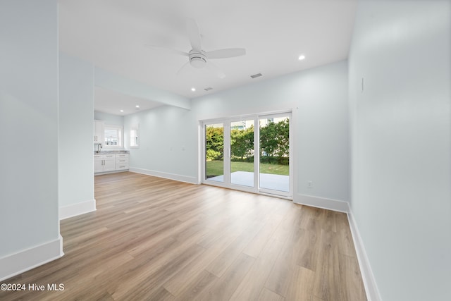 unfurnished room featuring light wood-type flooring and ceiling fan