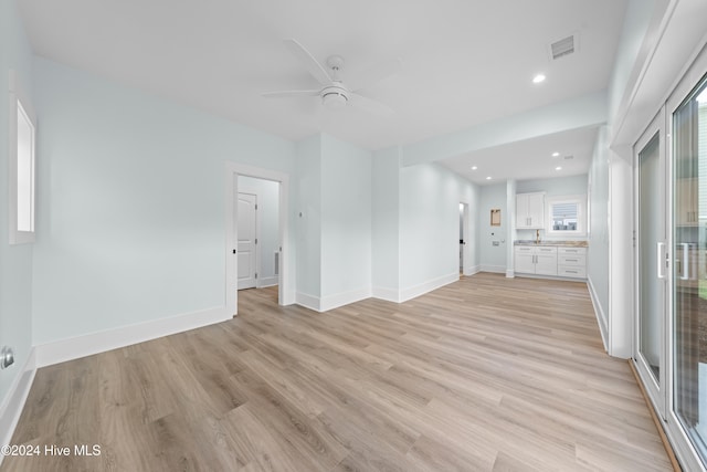 unfurnished living room with light hardwood / wood-style flooring and ceiling fan