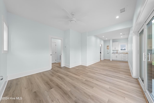 1405 Pinfish Ln, Carolina Beach, NC 28428 - unfurnished living room with light wood-style floors, ceiling fan, baseboards, and recessed lighting