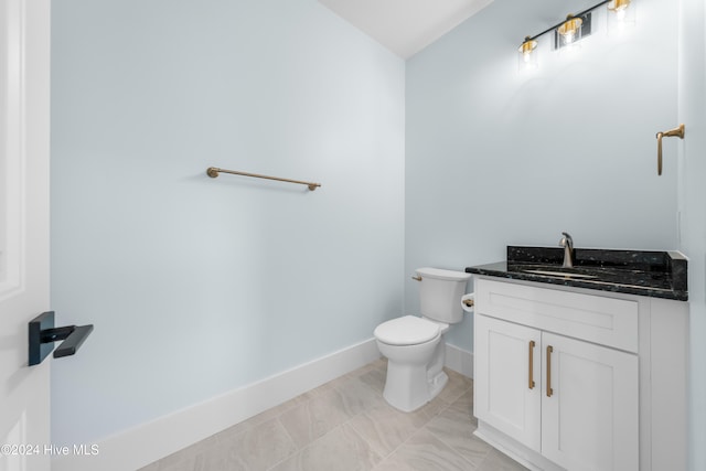 bathroom with toilet and vanity