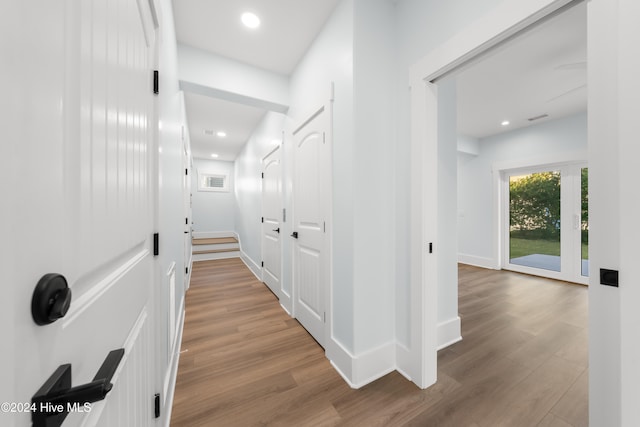 hallway with light hardwood / wood-style flooring