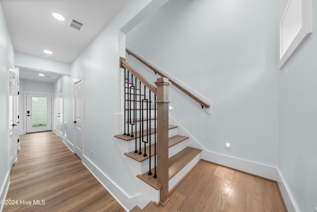 stairway with hardwood / wood-style floors