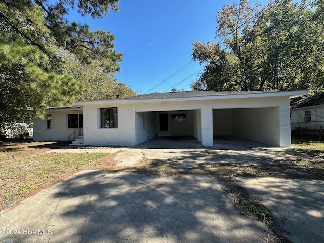 ranch-style house featuring a carport