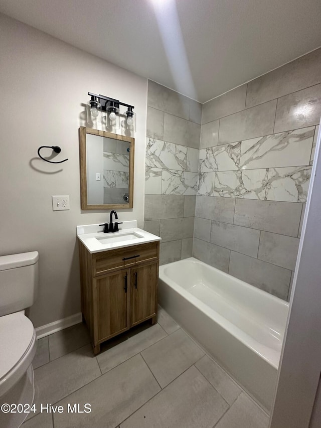 full bathroom featuring vanity, toilet, tiled shower / bath combo, and tile patterned flooring