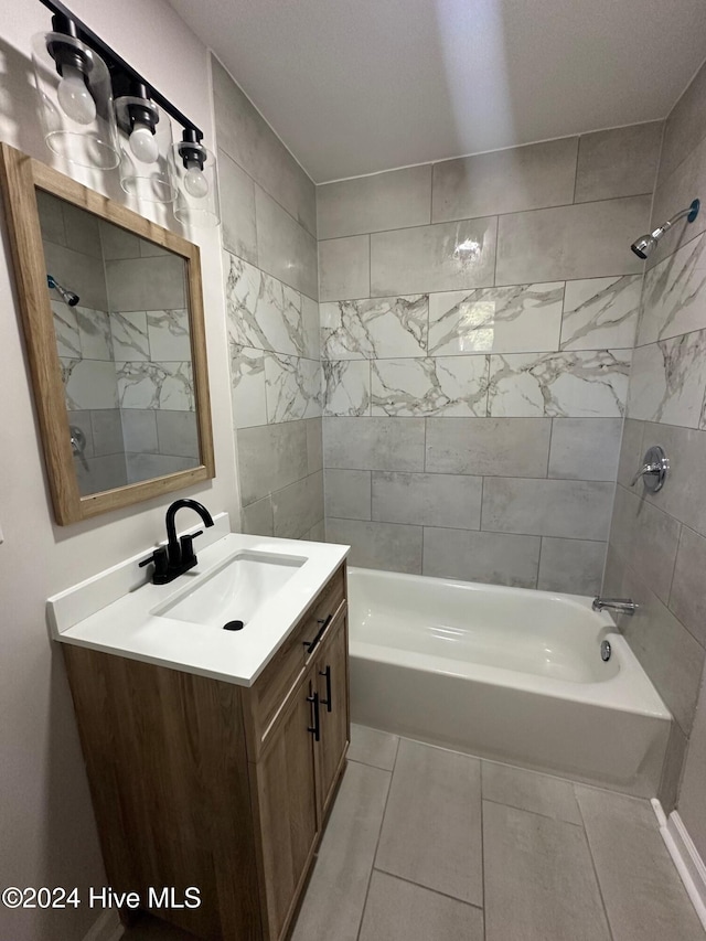 bathroom featuring vanity, tiled shower / bath combo, and tile patterned floors