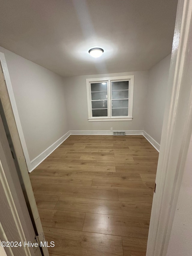 empty room featuring wood-type flooring