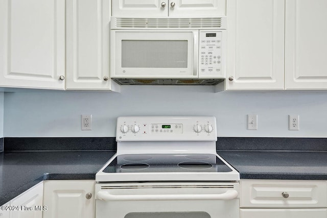 kitchen with white cabinets and white appliances