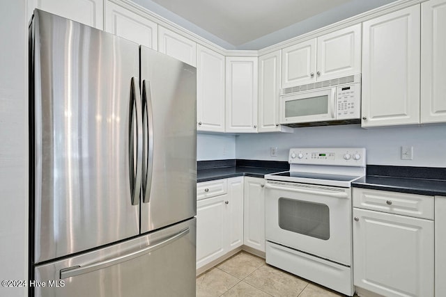 kitchen with white cabinetry, light tile patterned floors, and white appliances