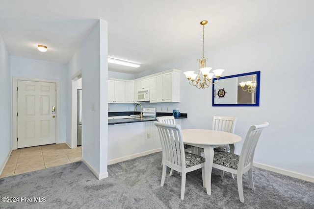 dining area featuring light colored carpet, an inviting chandelier, and sink