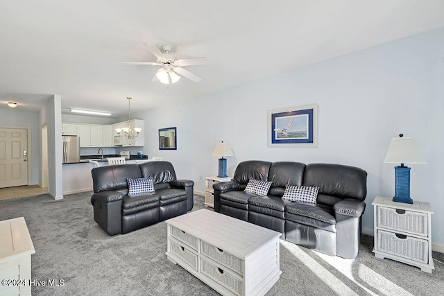 carpeted living room with ceiling fan with notable chandelier and sink