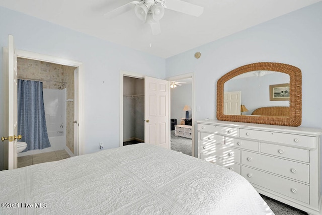 bedroom with carpet, connected bathroom, a closet, and ceiling fan