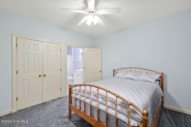 bedroom with dark colored carpet, a closet, ensuite bathroom, and ceiling fan