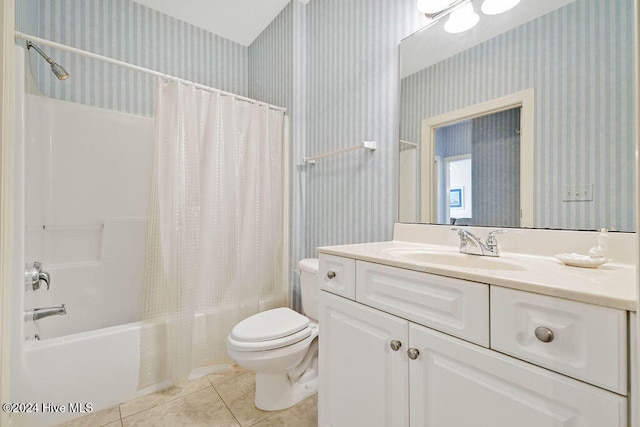 full bathroom featuring tile patterned flooring, vanity, toilet, and shower / bathtub combination with curtain