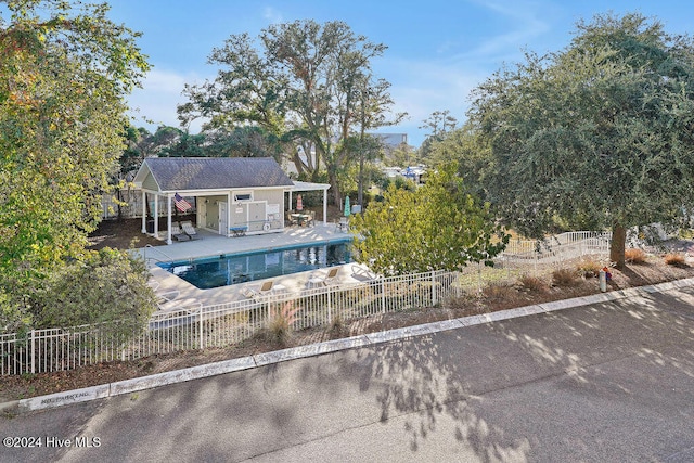 exterior space featuring a patio area and a fenced in pool