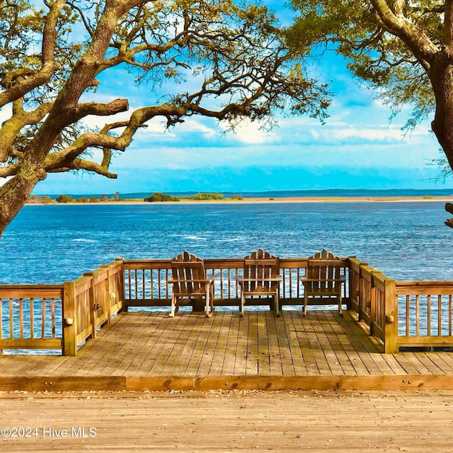 dock area featuring a deck with water view