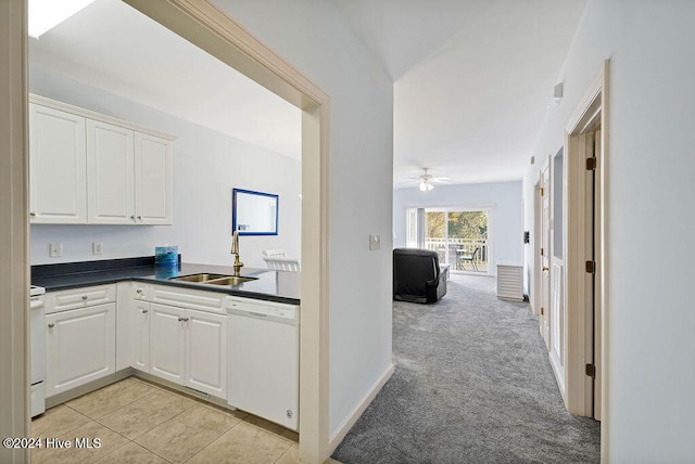 kitchen featuring white appliances, light colored carpet, ceiling fan, sink, and white cabinets