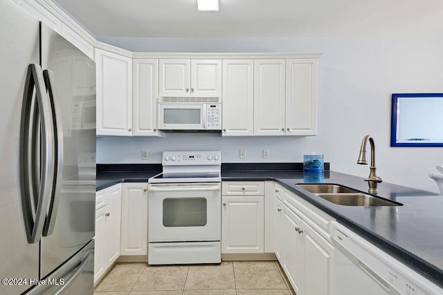 kitchen featuring white cabinets, light tile patterned flooring, white appliances, and sink