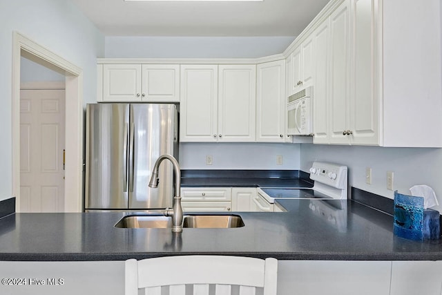 kitchen with kitchen peninsula, white cabinetry, white appliances, and sink