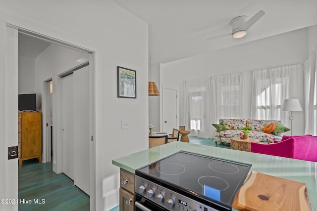 kitchen with stainless steel electric range oven, ceiling fan, and wood-type flooring