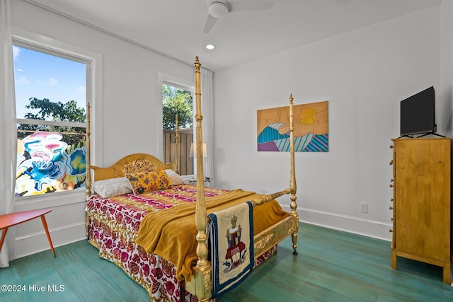 bedroom with hardwood / wood-style floors, ceiling fan, and multiple windows