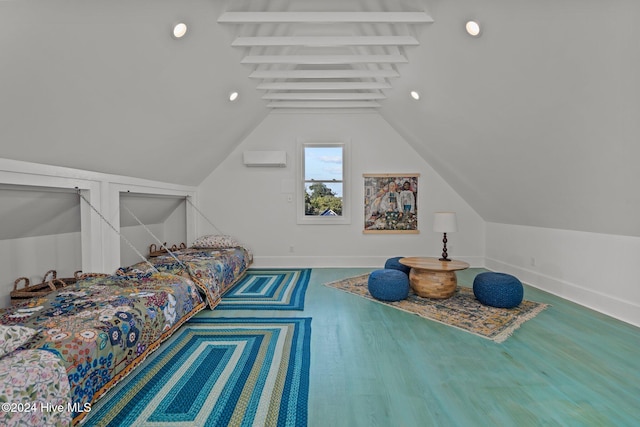 bedroom featuring hardwood / wood-style floors and vaulted ceiling with beams