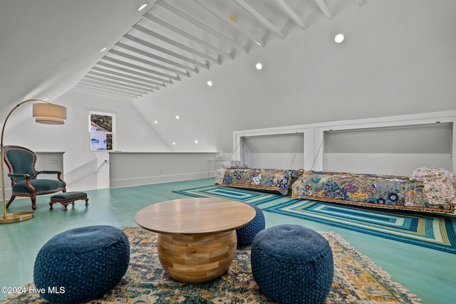 living area with vaulted ceiling with beams