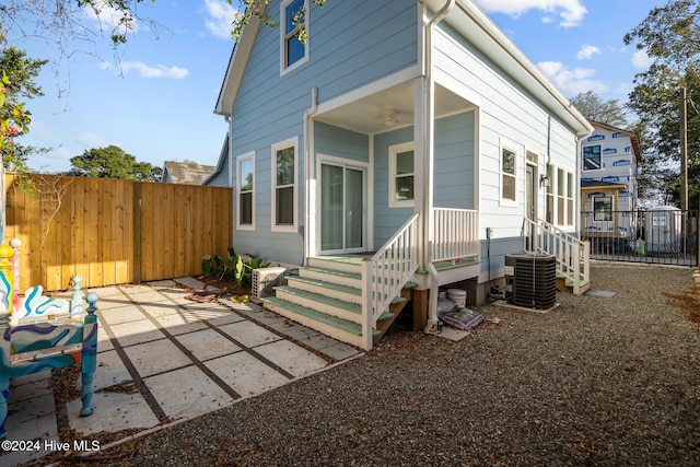 view of home's exterior featuring cooling unit and ceiling fan