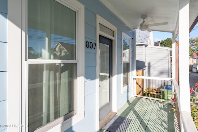 balcony with a porch and ceiling fan