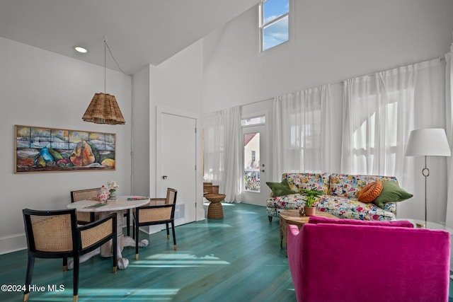 living room with hardwood / wood-style floors, a wealth of natural light, and high vaulted ceiling