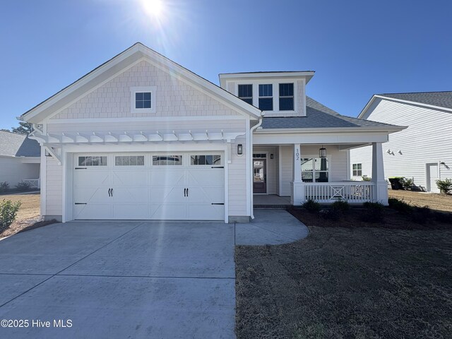 view of front facade featuring a garage and covered porch