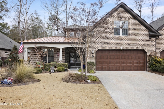 view of property featuring a porch and a garage