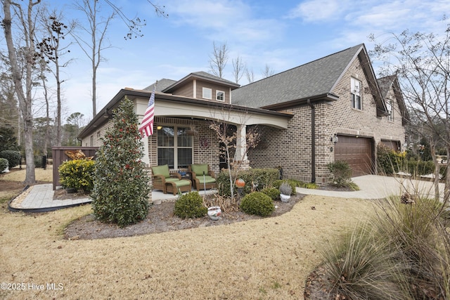 view of front of property featuring an outdoor hangout area and a garage