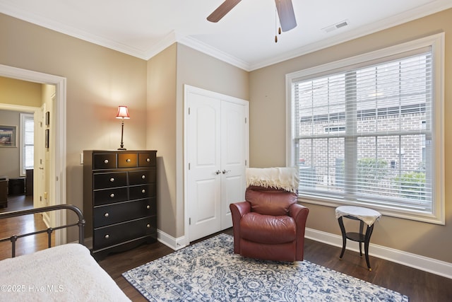 bedroom featuring multiple windows, a closet, ceiling fan, and ornamental molding