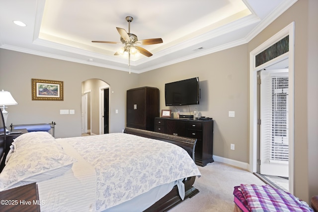 carpeted bedroom with a tray ceiling, access to exterior, ceiling fan, and ornamental molding