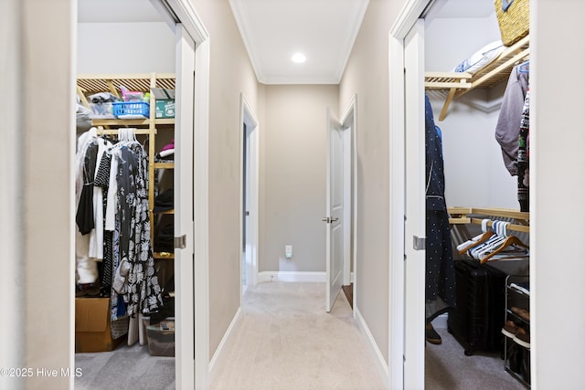 hallway with light colored carpet and crown molding