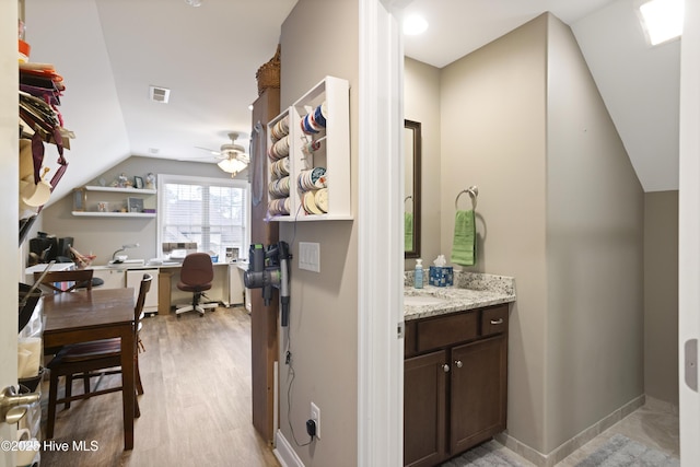 bathroom featuring ceiling fan, hardwood / wood-style floors, vanity, and lofted ceiling