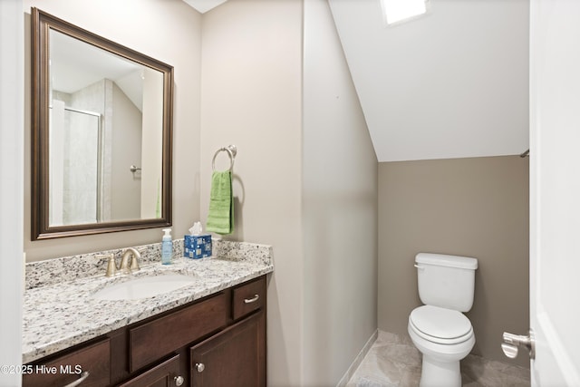 bathroom featuring vanity, toilet, lofted ceiling, and a shower with shower door