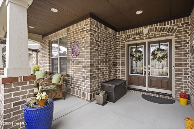 view of exterior entry with a porch