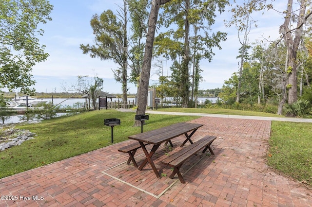 view of property's community featuring a yard and a water view