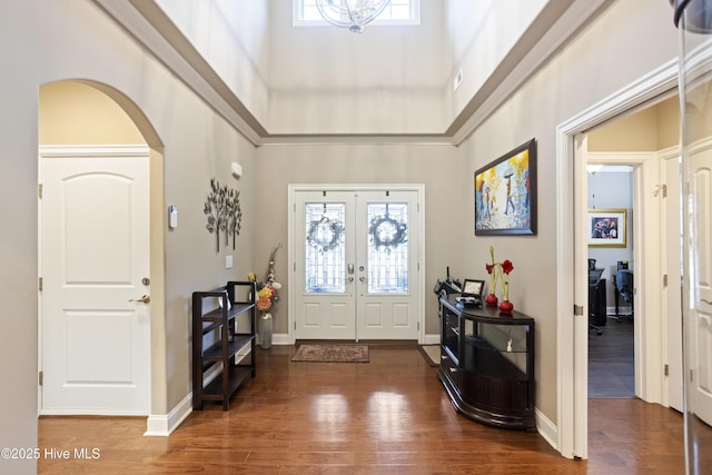 entryway featuring dark hardwood / wood-style flooring, a high ceiling, and french doors