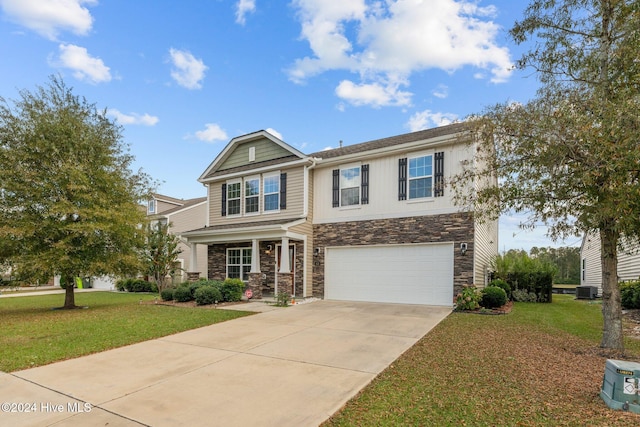 view of front of home with driveway, a front lawn, stone siding, an attached garage, and central AC unit