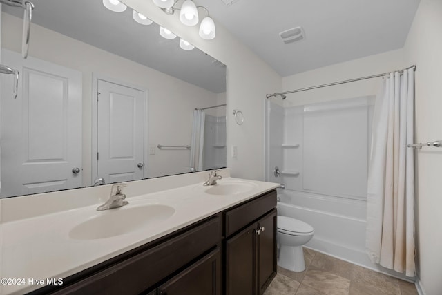 full bathroom featuring shower / bath combo with shower curtain, vanity, and toilet